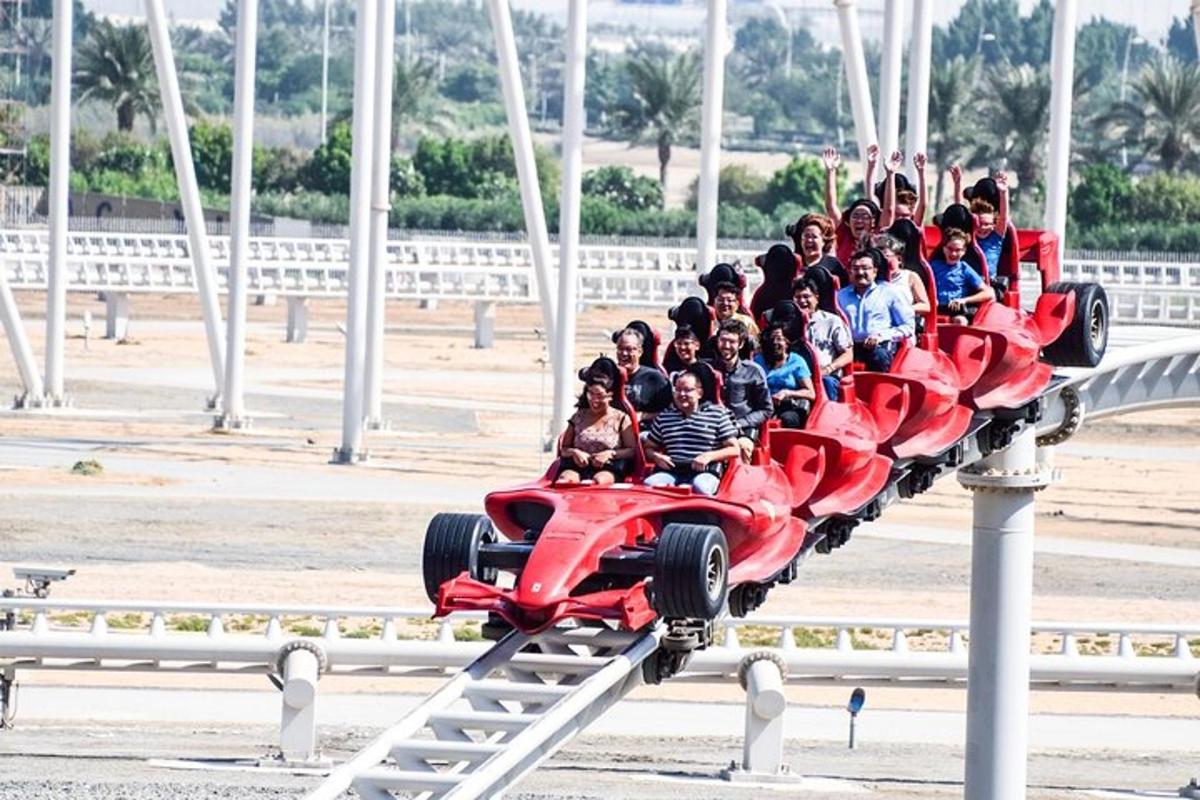 a group of people riding a red car on a roller coaster
