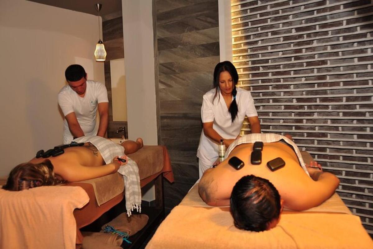 a group of people making beds in a room