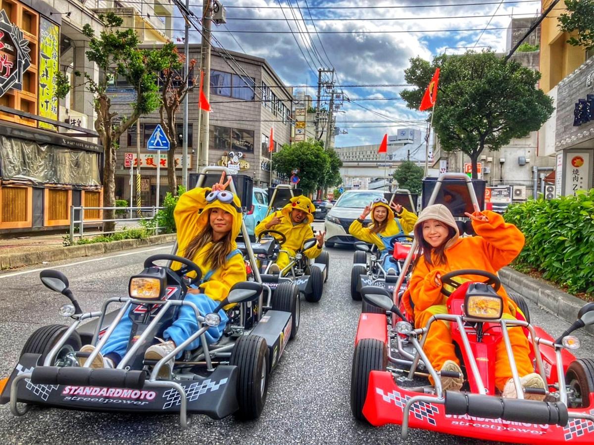 a group of people in costumes riding on trikes down a street