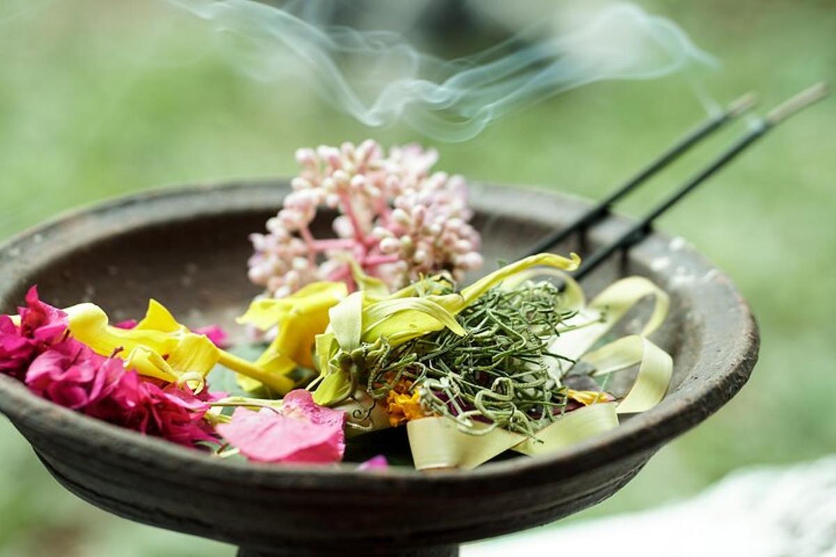 a bowl filled with flowers and chopsticks