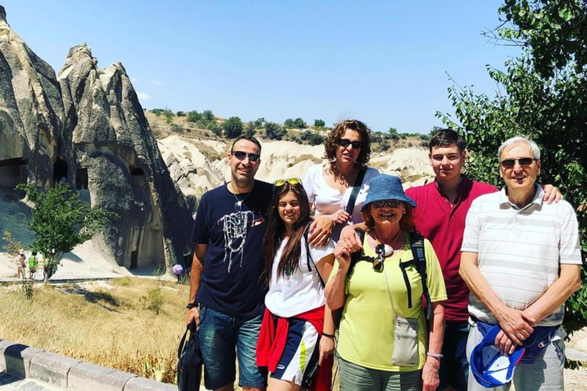a group of people posing for a picture in front ofartifacts