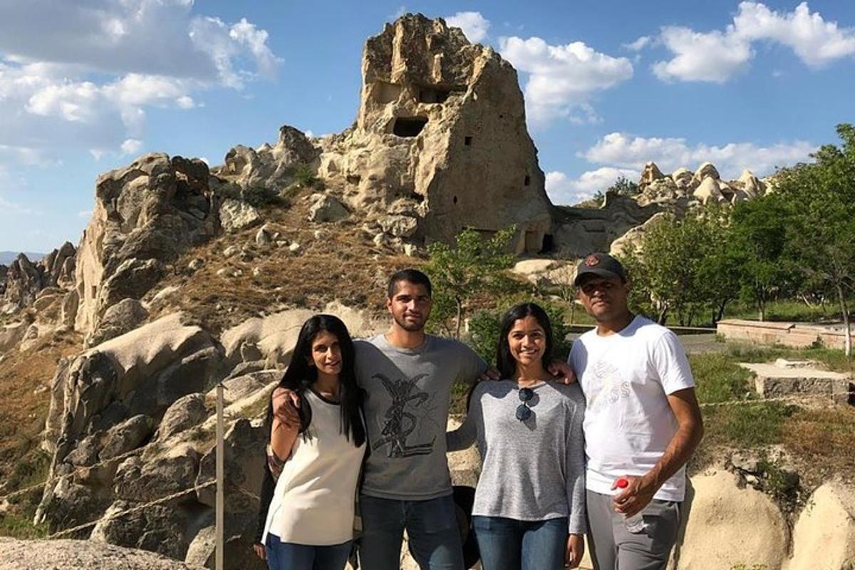 a group of people standing in front of a mountain