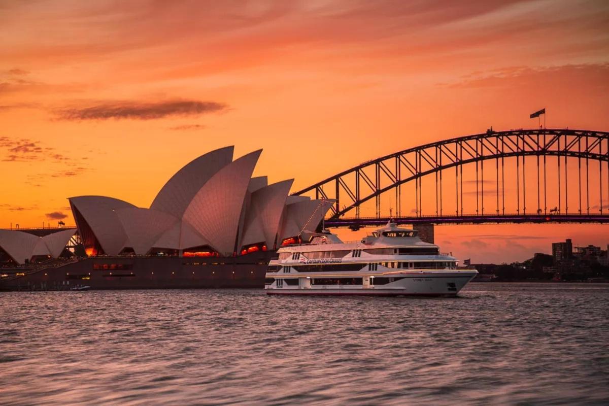 a cruise ship in the water with a bridge and opera house