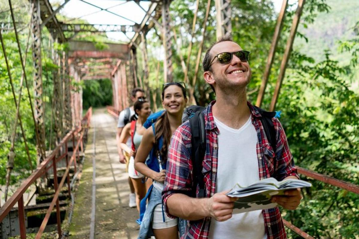 a group of people walking across a bridge