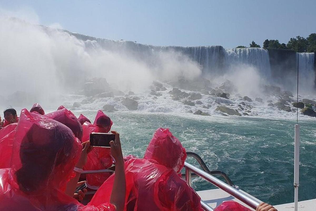 a group of people dressed in pink on a boat in niagara falls