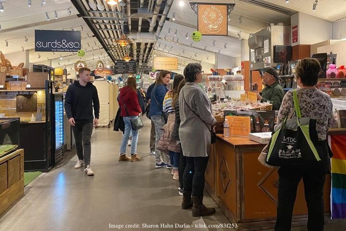 a group of people standing around a counter in a store