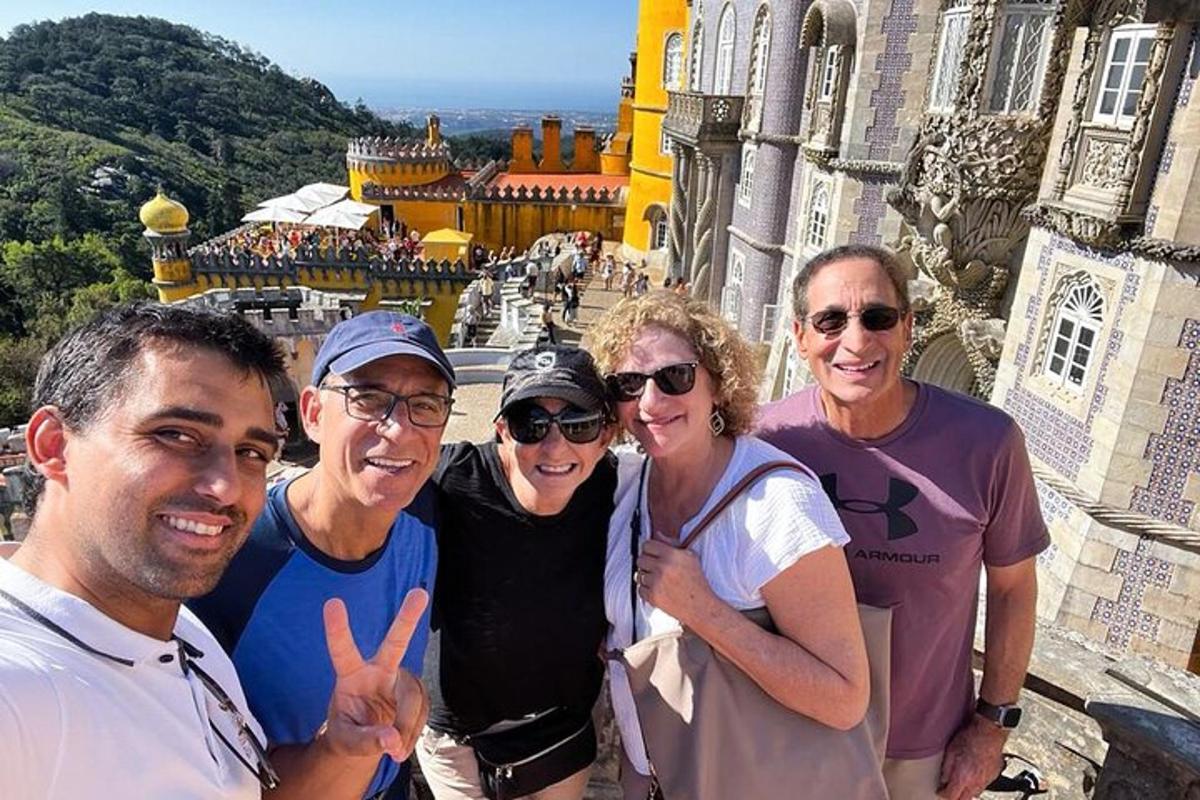 a group of people posing for a picture in front of a castle