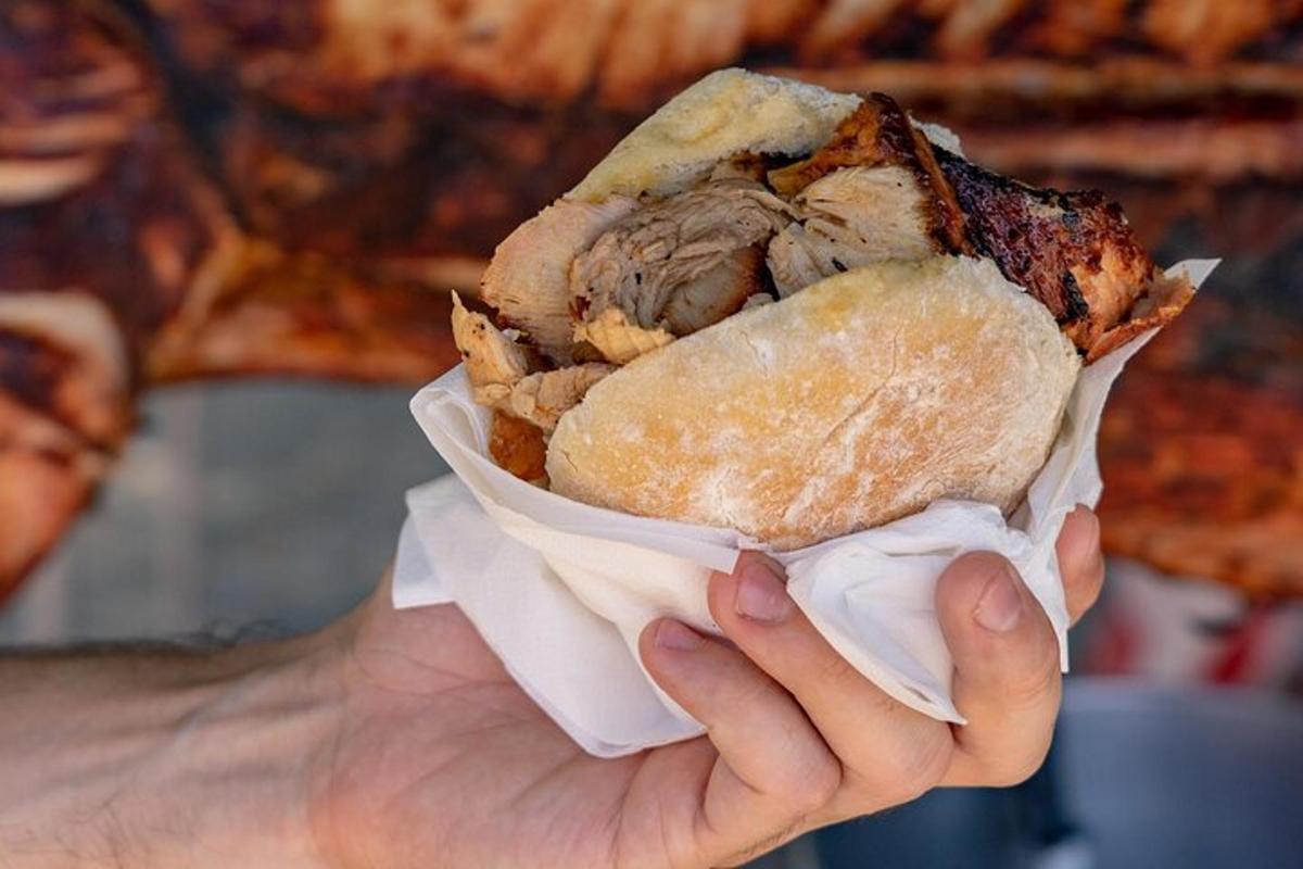 a person holding a sandwich in a wrapper