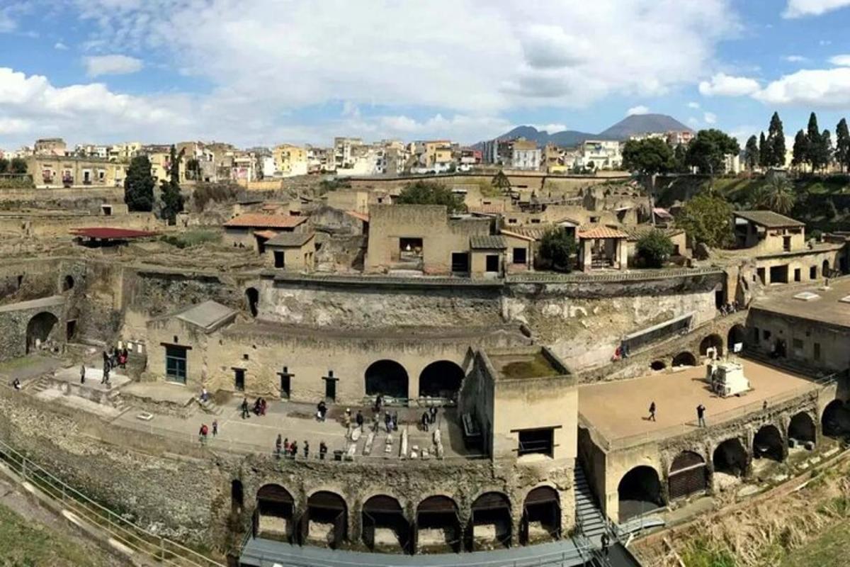 an old amphitheater with a city in the background