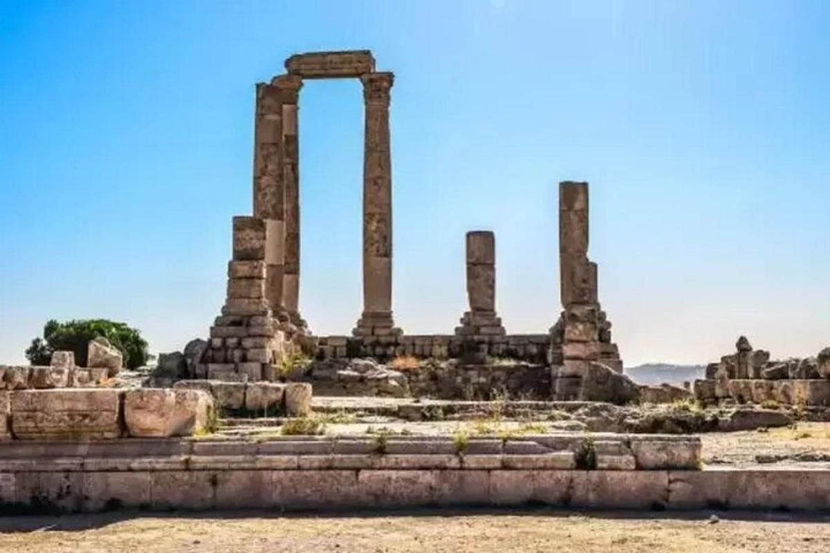 an ancient temple with columns in the background