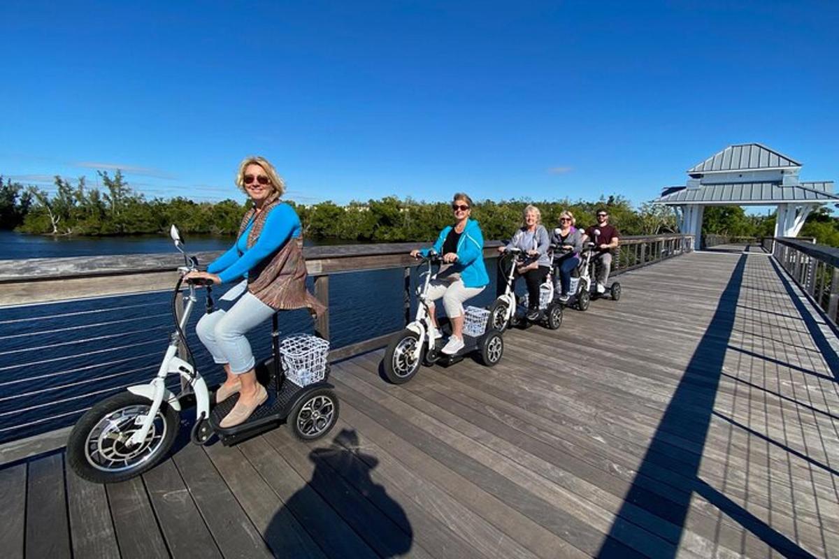 a group of people riding scooters on a boardwalk