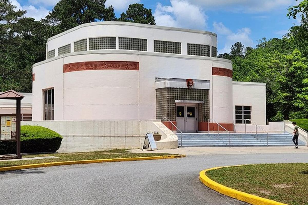 a large white building with a staircase in front of it