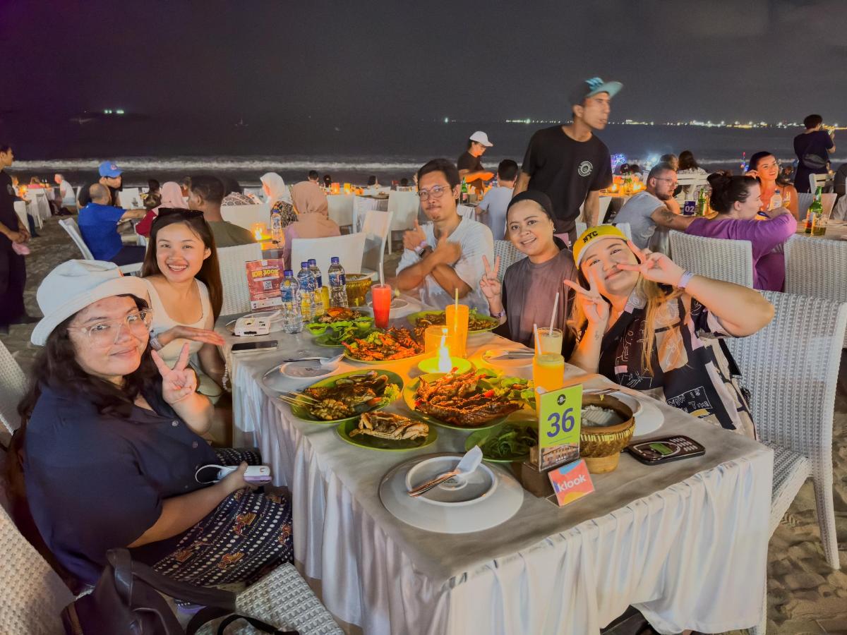 a group of people sitting at a table with food