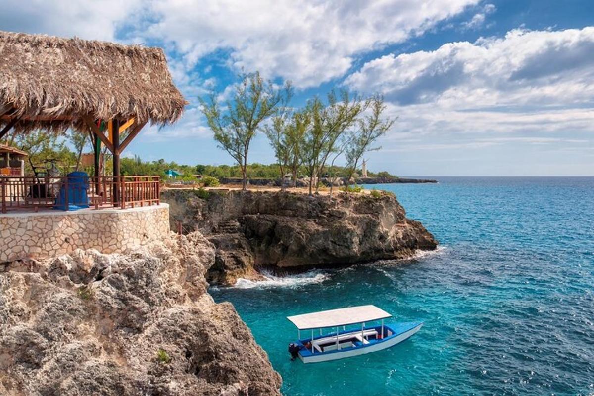 a boat in the water next to a resort