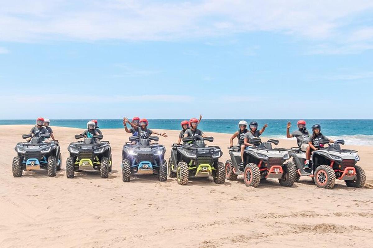 a group of people riding atvs on the beach