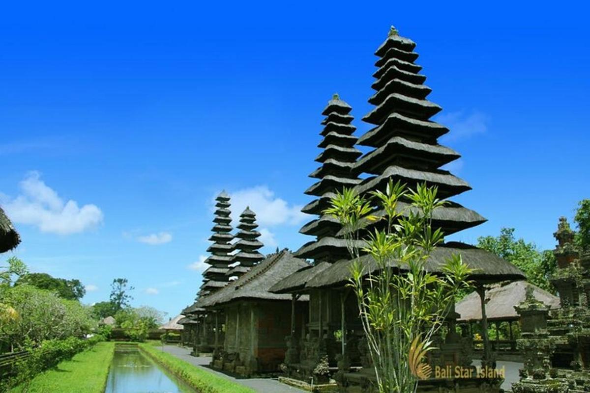 a group of pagoda style buildings with water in front