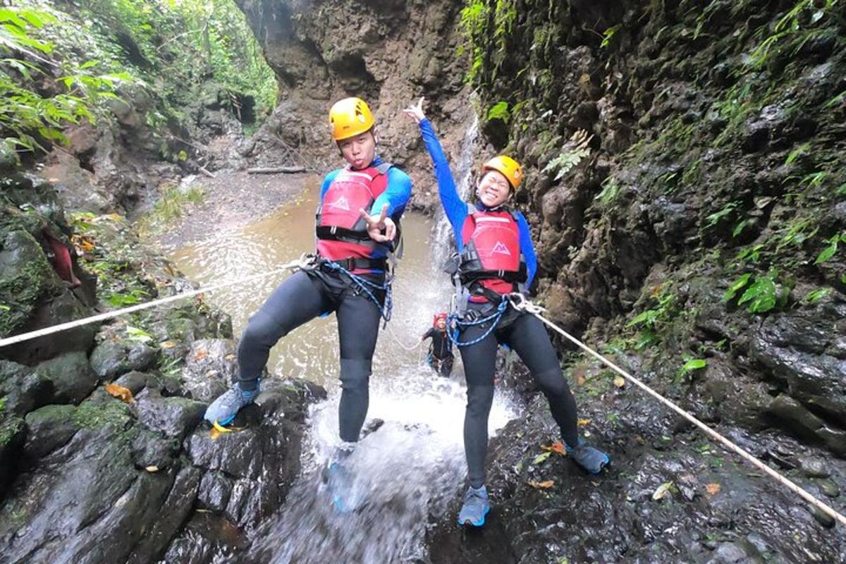 two people on a zip line in a river