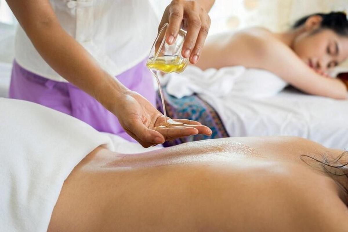 a man getting a massage with a glass of wine