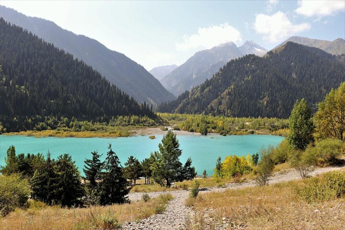 a blue lake in the middle of a mountain