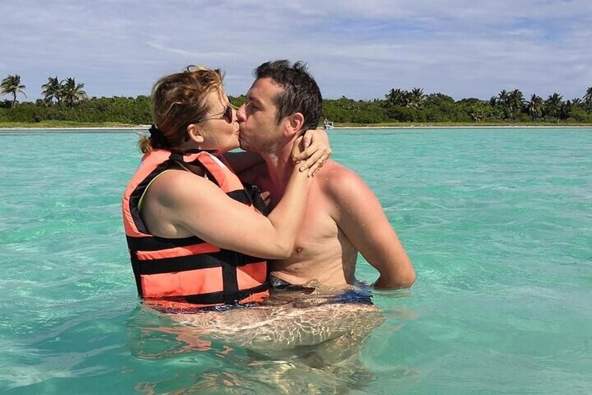 Un hombre y una mujer besándose en el agua