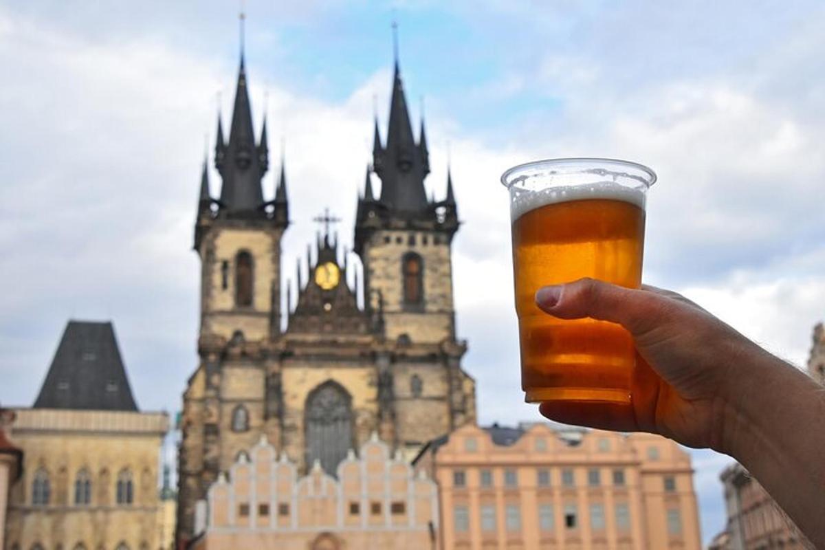 a person holding a glass of beer in front of a building