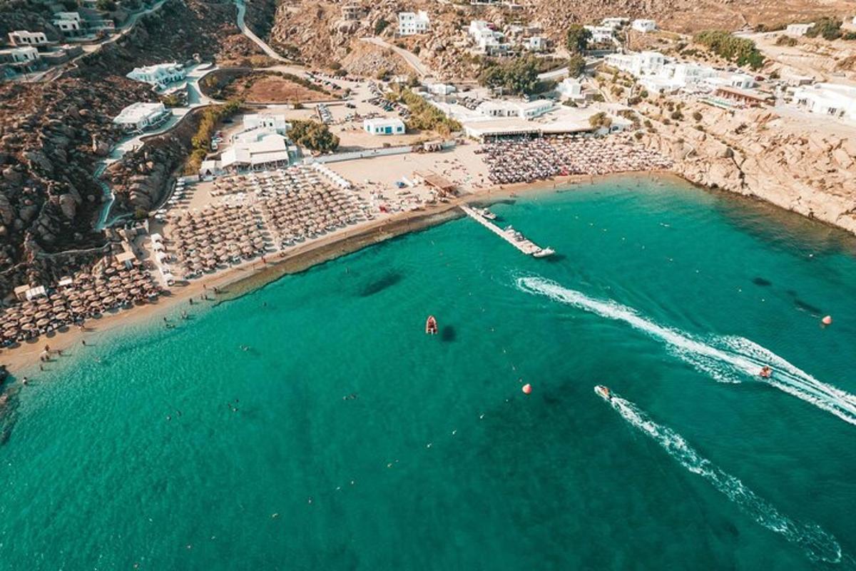 an aerial view of a beach with boats in the water