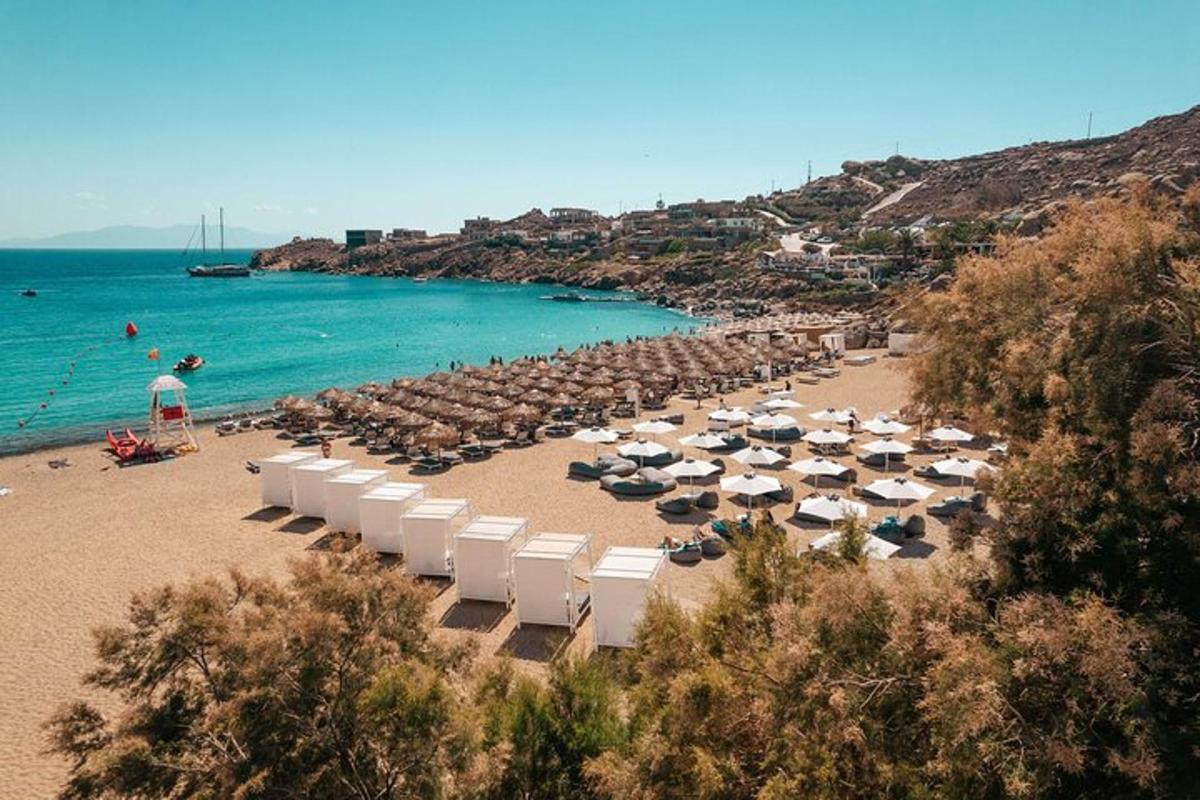 a beach with umbrellas and chairs and the ocean