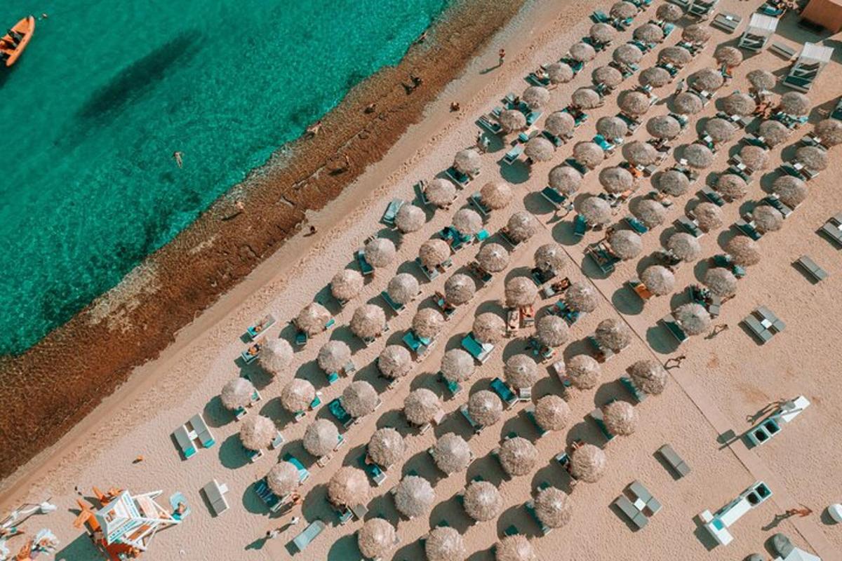 an overhead view of a beach with a bunch of umbrellas