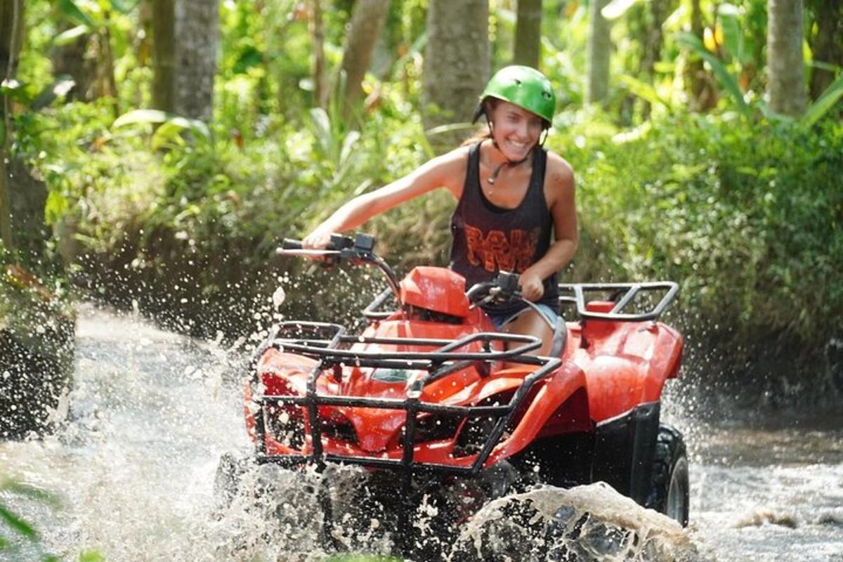 a woman riding a wheeler through a river