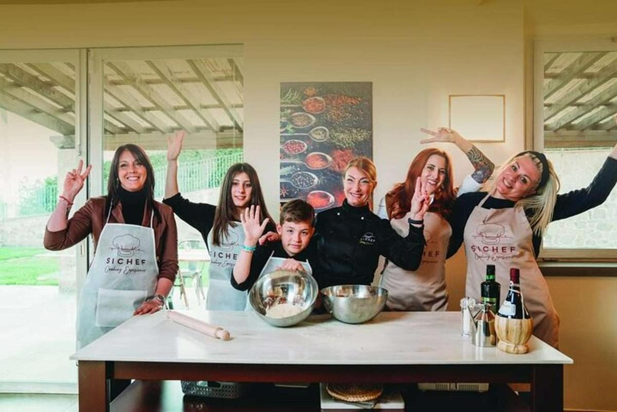a group of people standing around a table with their hands up