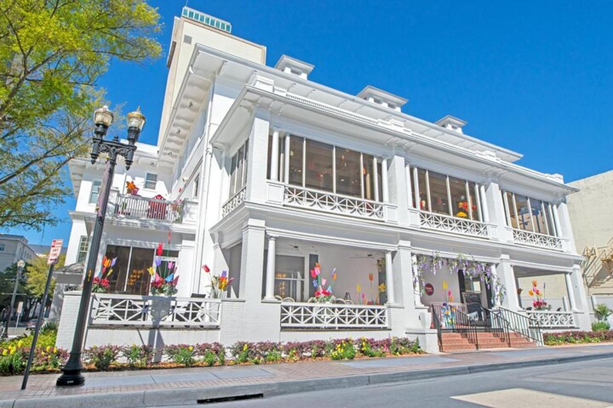 a white building with lots of windows on a street
