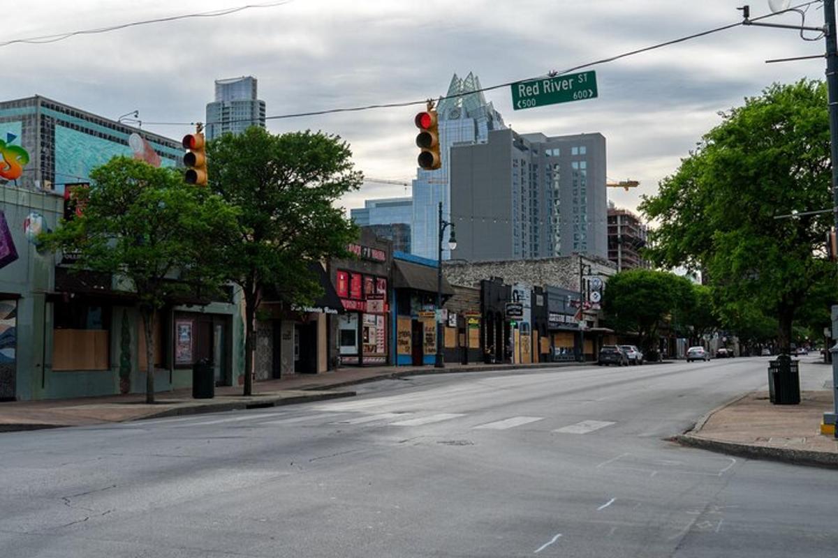 an empty city street with a red traffic light