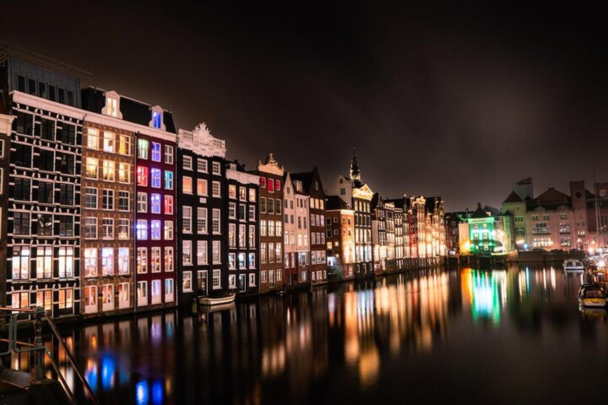 a group of buildings on a river at night