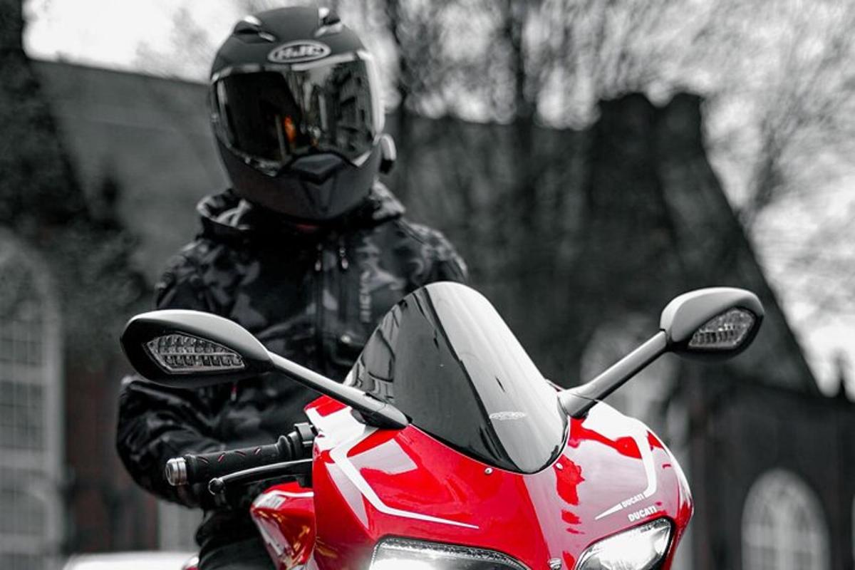 a person wearing a helmet sitting on a red motorcycle