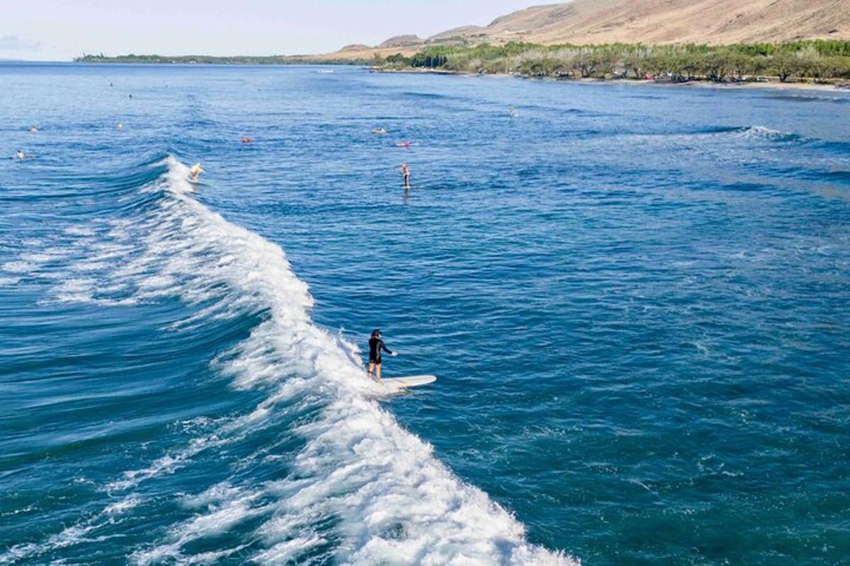 una persona che cavalca un'onda su una tavola da surf in acqua