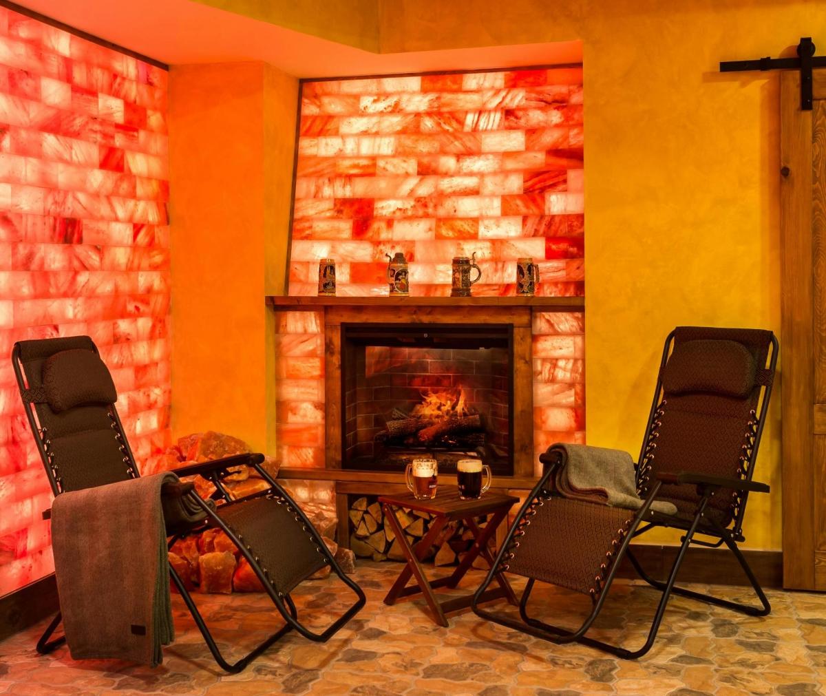a living room with two chairs and a fireplace