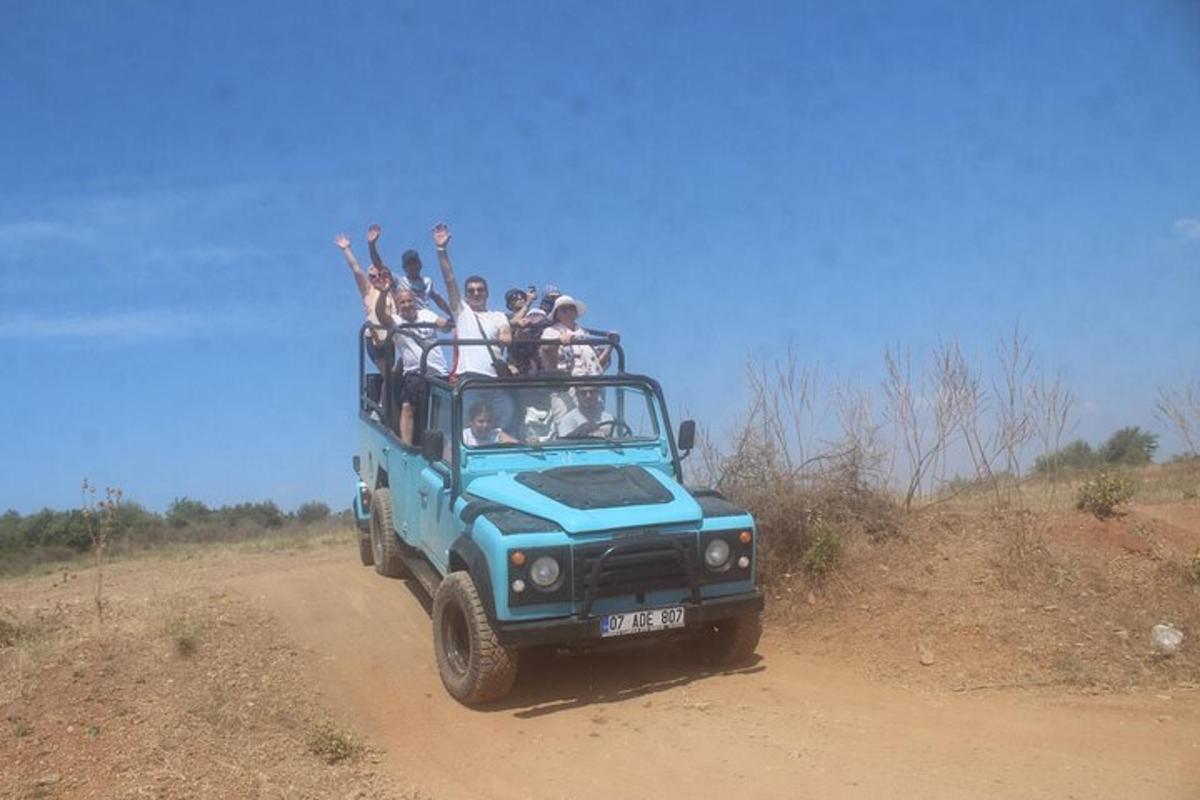 a group of people riding on the back of a jeep