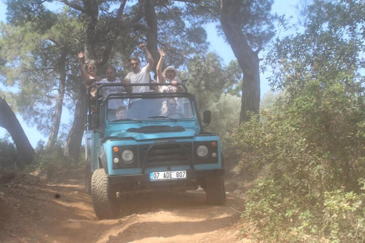 un gruppo di persone che viaggiano su un camion su una strada sterrata