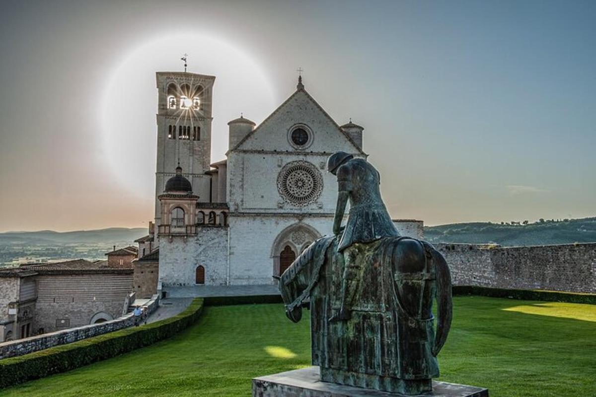 una statua di fronte a un edificio con una torre dell'orologio