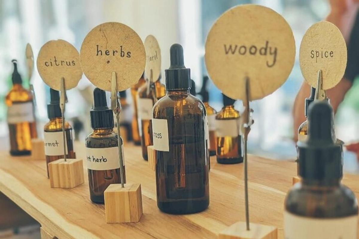 a group of bottles of oils on a wooden table