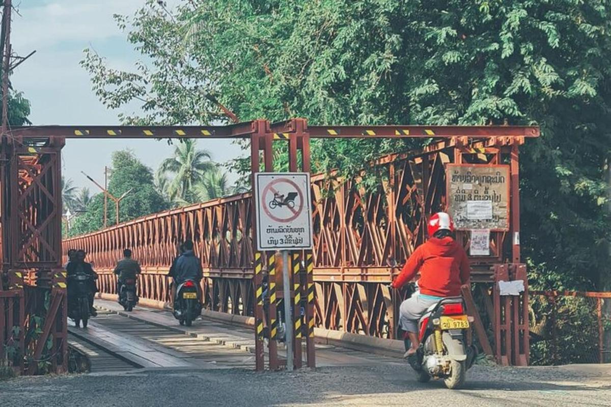a group of people riding motorcycles on a bridge