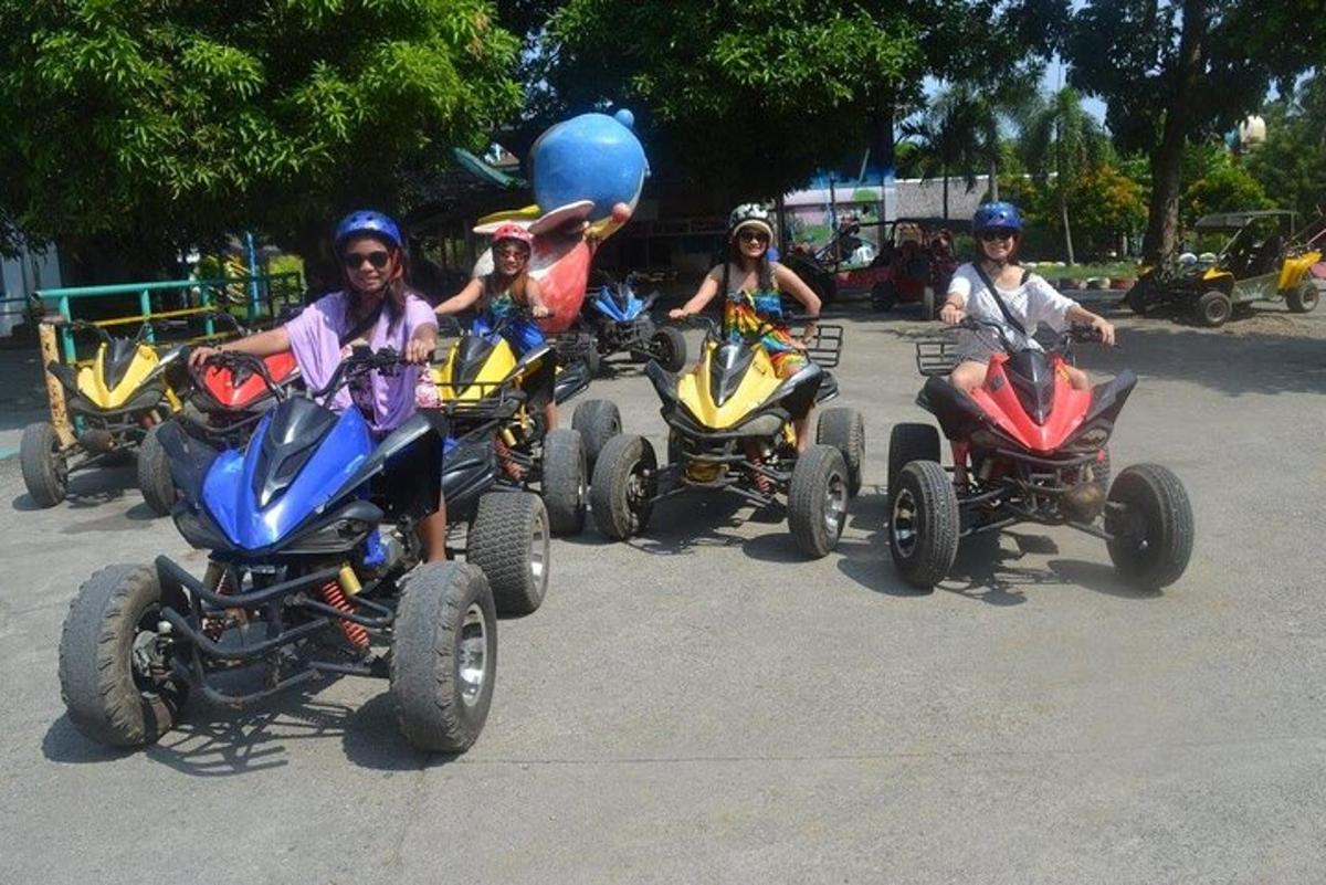 a group of people riding on four wheel vehicles