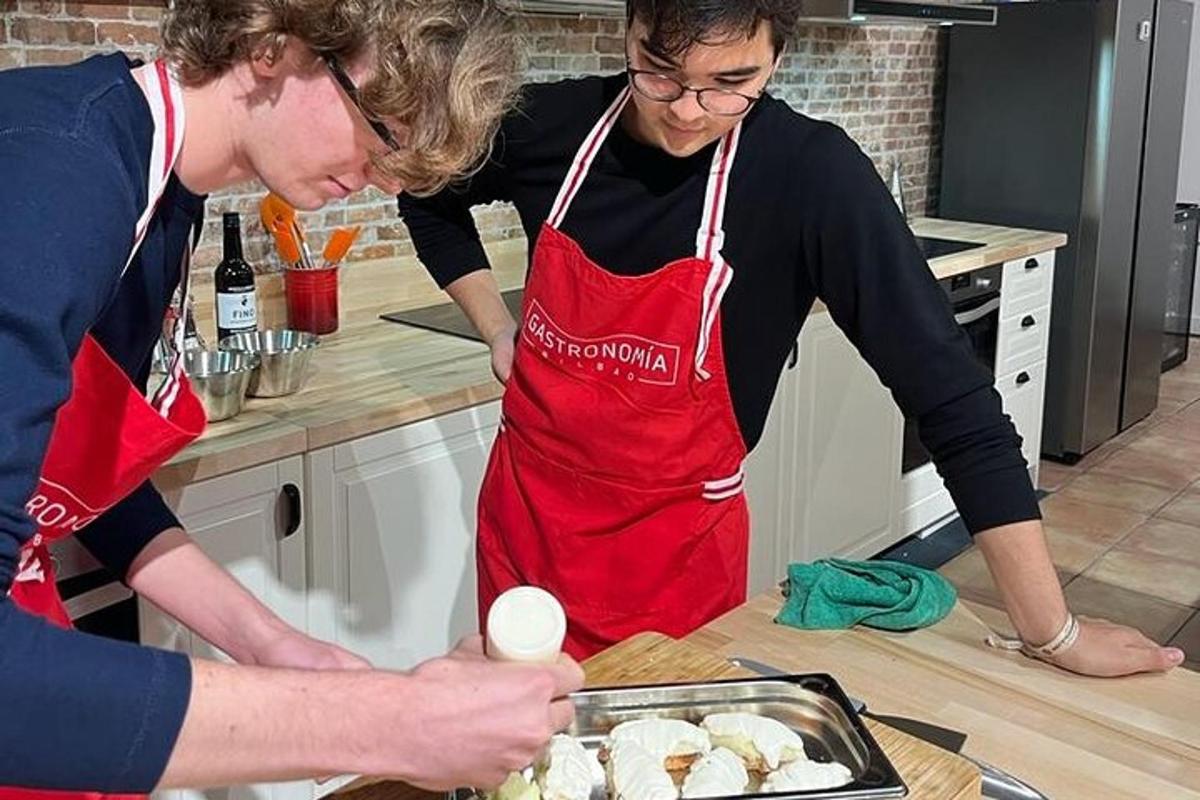 two people standing in a kitchen preparing food