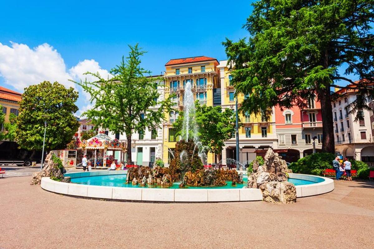 a fountain in the middle of a street with a building
