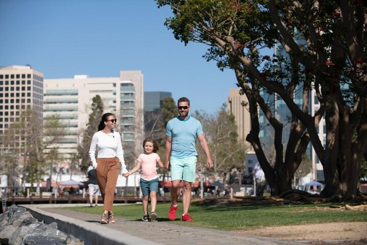 a family walking down a sidewalk in a park