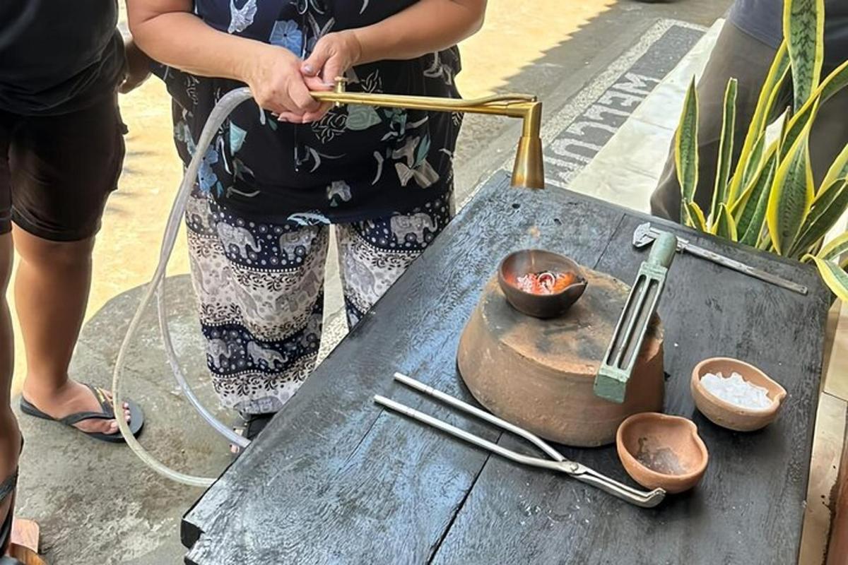 a woman standing next to a table with a pot