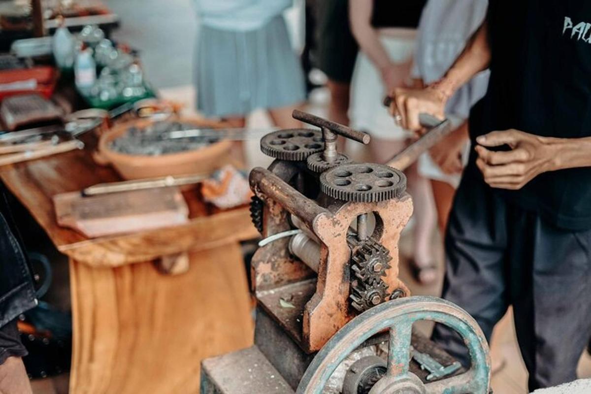 a wooden table with people standing around a wooden table with a grinding machine