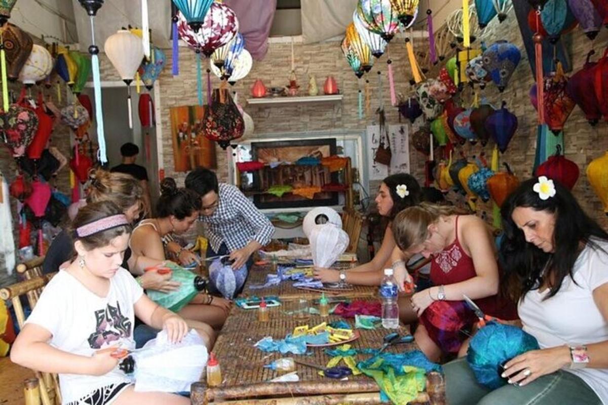 a group of people sitting around a table making crafts