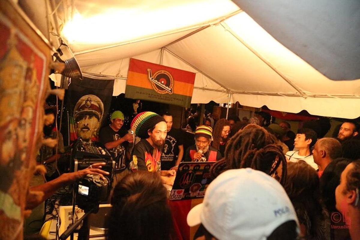 a group of people sitting in a crowd in a tent