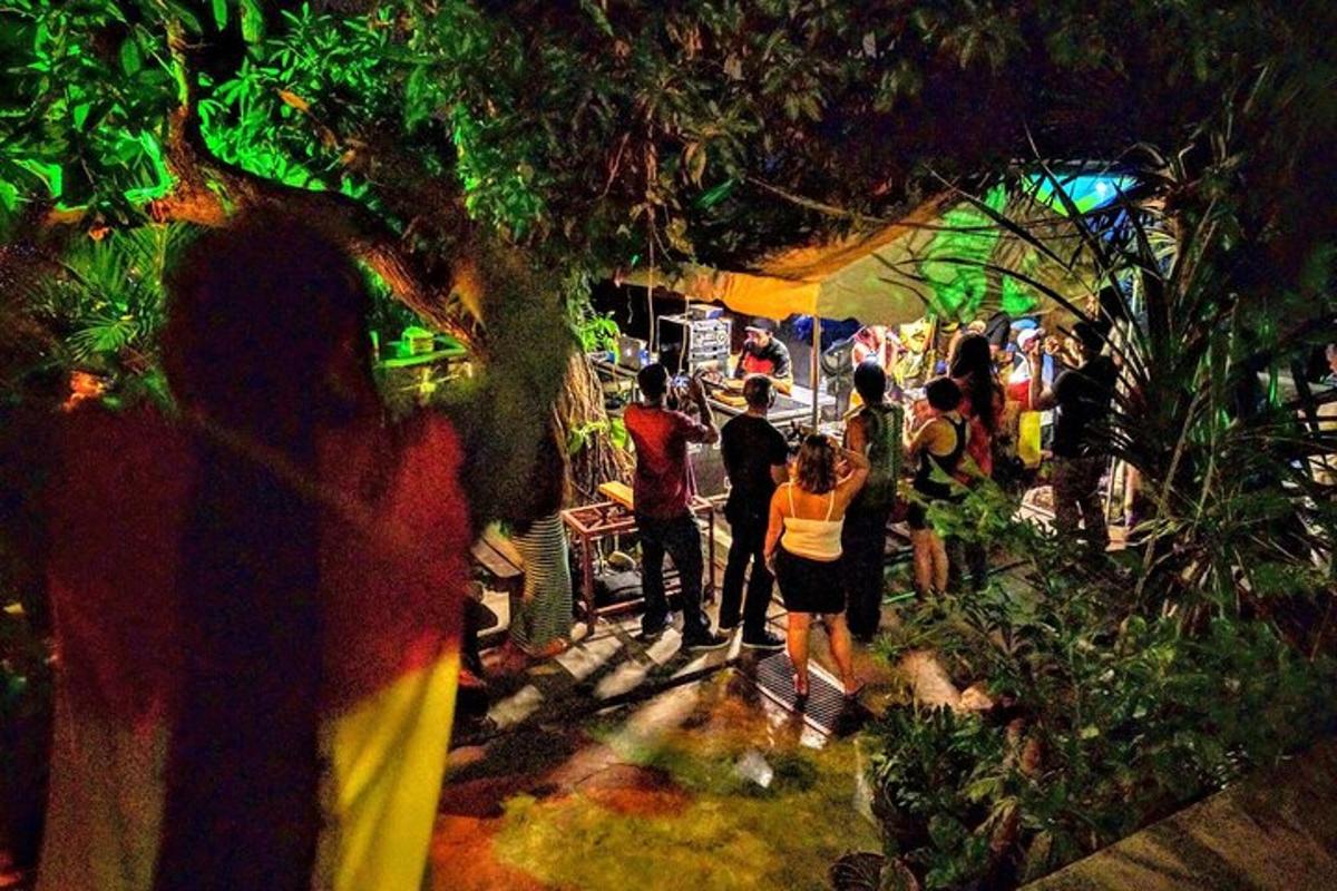 a crowd of people standing around an outdoor market